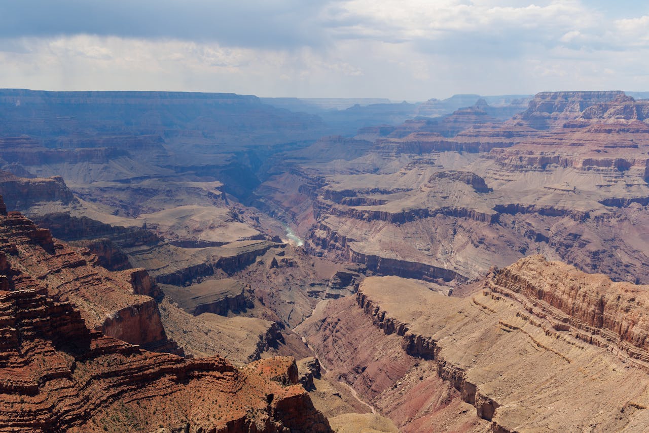 services-03 Expansive aerial view of the Grand Canyon showcasing layers of rock formations.